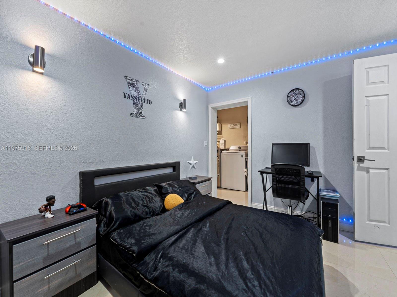 30236 Southwest 148th Place Homestead, FL 33033 - Photo 19 of 69 a bedroom with a bed and a flat screen tv