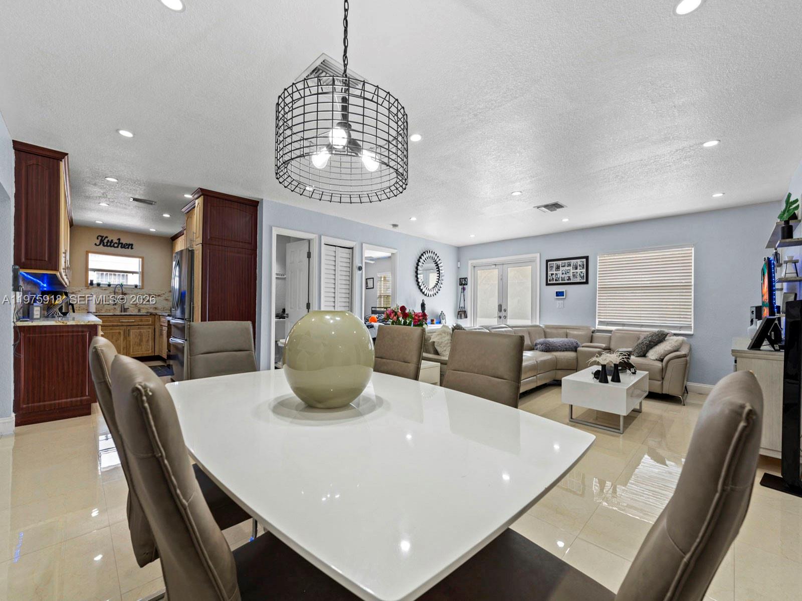 30236 Southwest 148th Place Homestead, FL 33033 - Photo 28 of 69 a living room with couches a dining table and chairs with wooden floor
