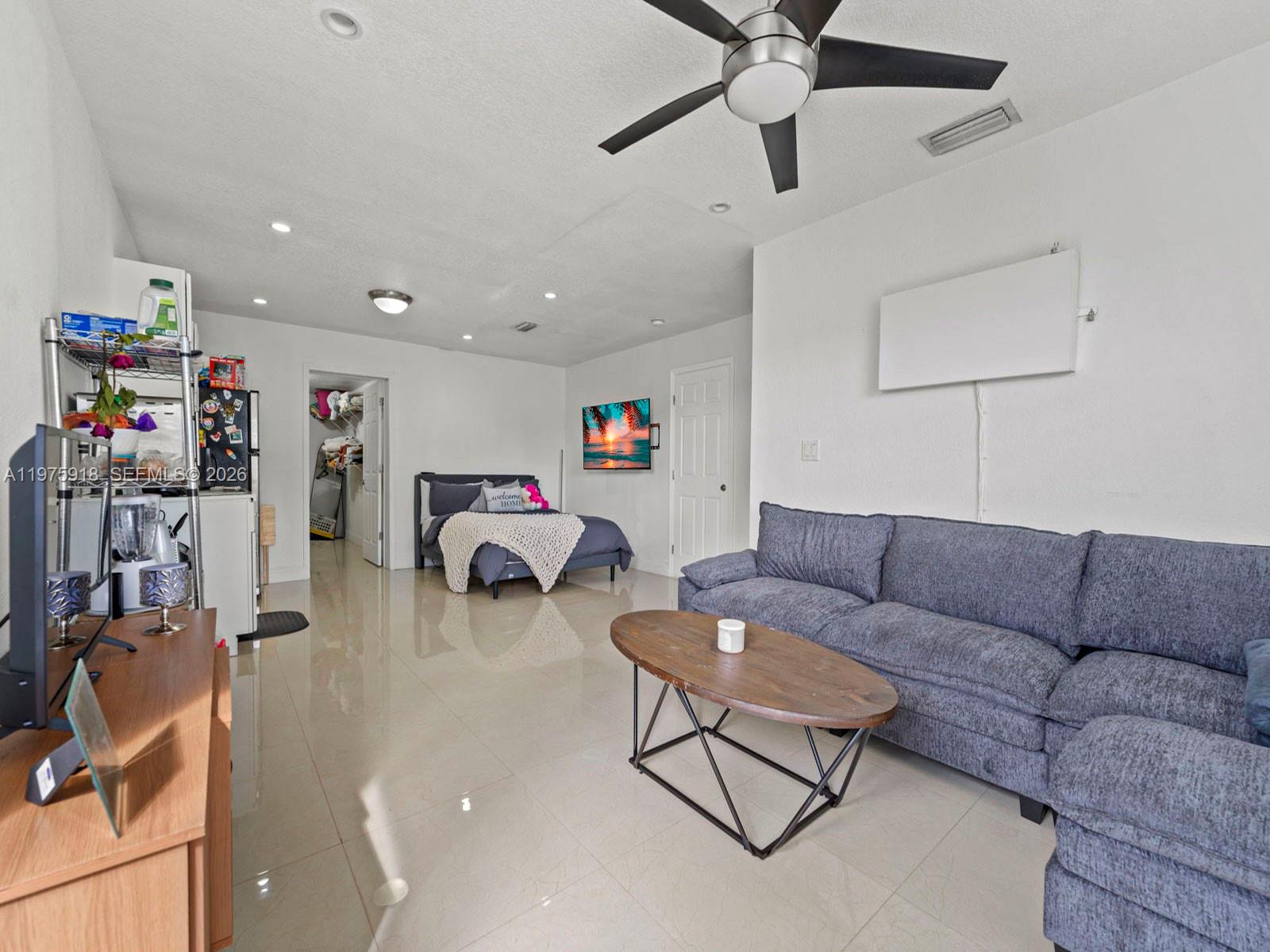 30236 Southwest 148th Place Homestead, FL 33033 - Photo 35 of 69 a living room with furniture and a flat screen tv