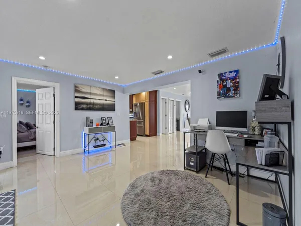 a living room with furniture and kitchen view