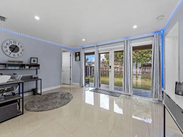 a living room with furniture and kitchen view