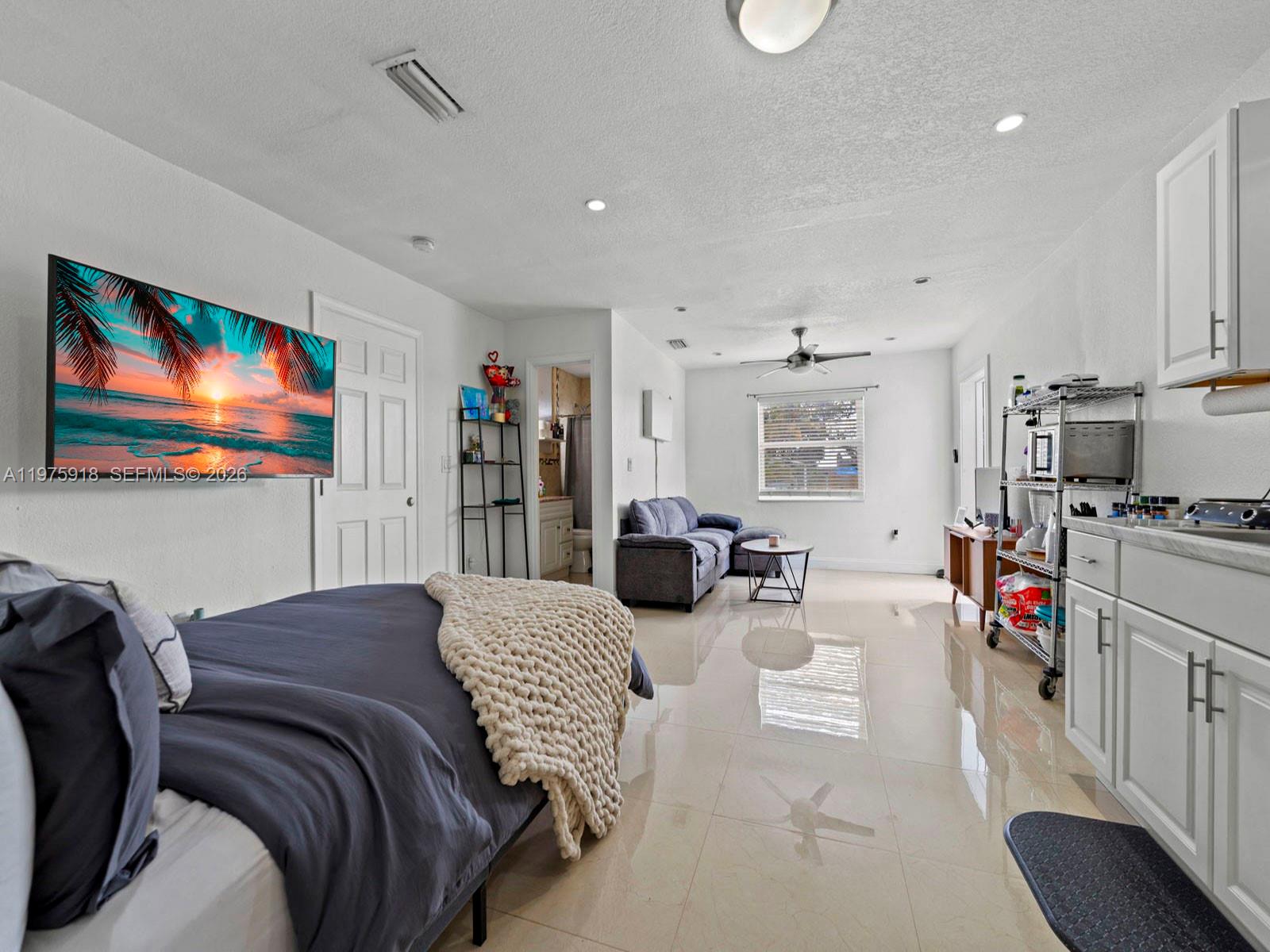 30236 Southwest 148th Place Homestead, FL 33033 - Photo 10 of 69 a bedroom with furniture and a flat screen tv