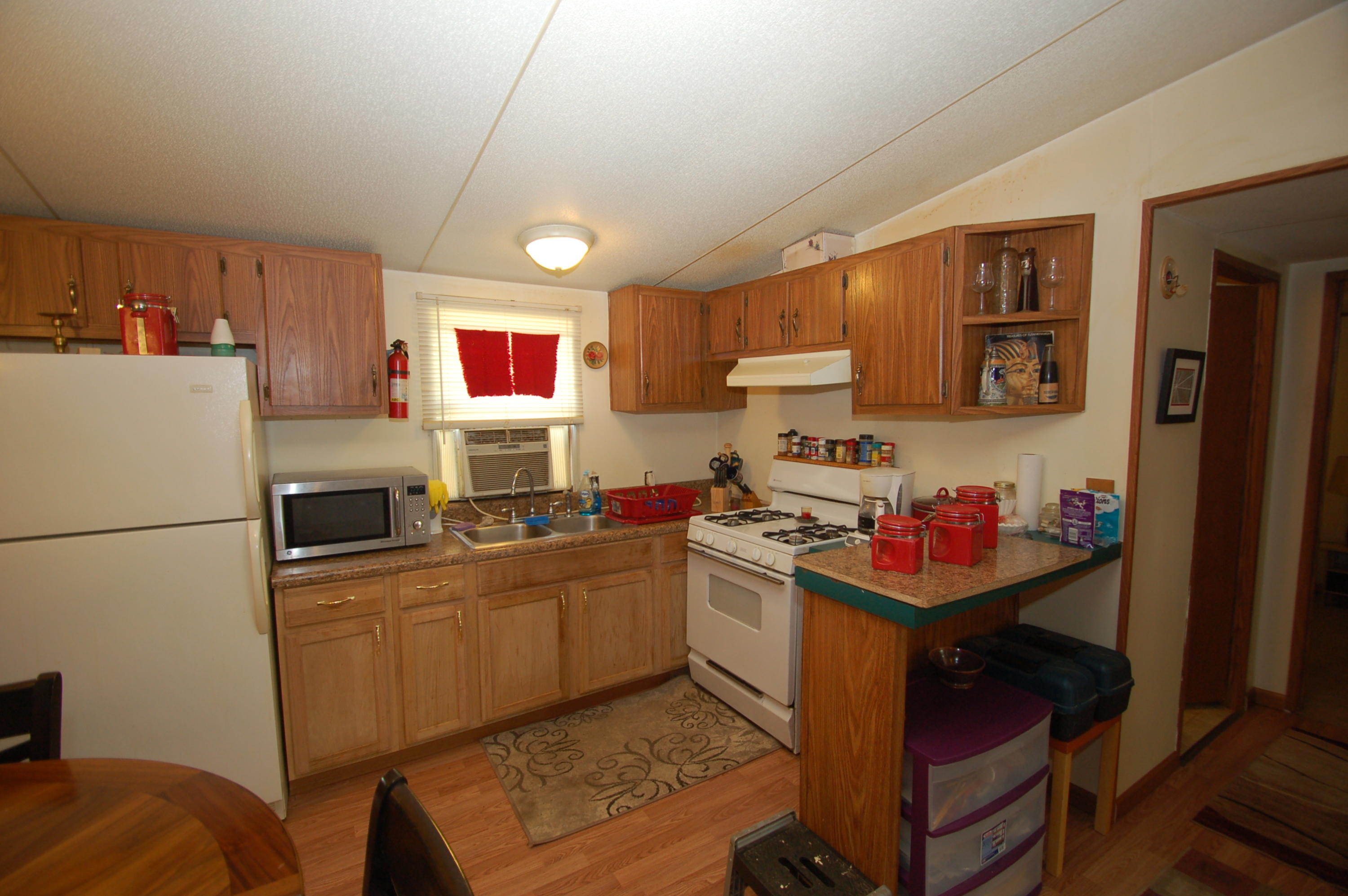 3189 Half Acre Of Rocks Road Elliston, VA 24087 - Photo 4 of 24 a kitchen with a refrigerator a stove top oven a sink and dishwasher