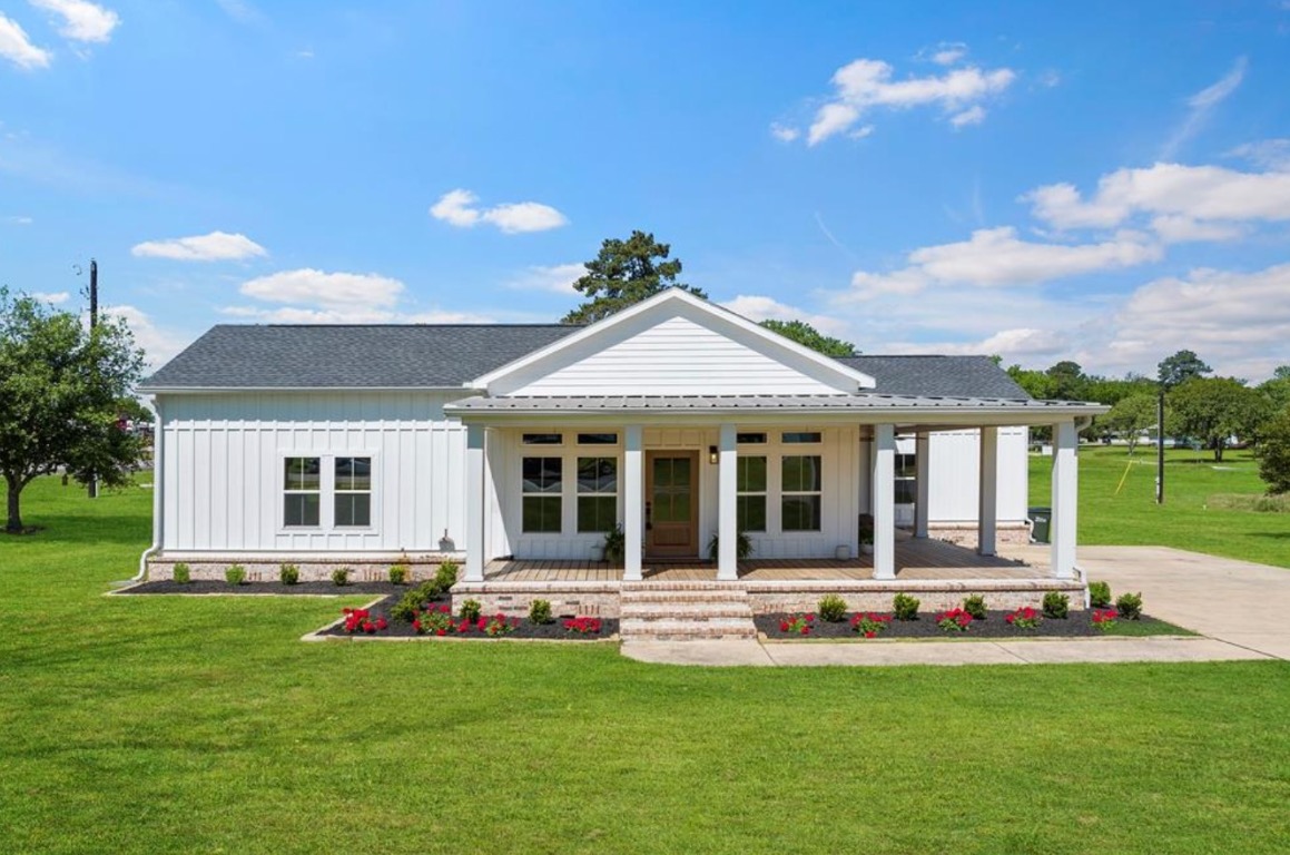 a front view of house with yard outdoor seating and green space