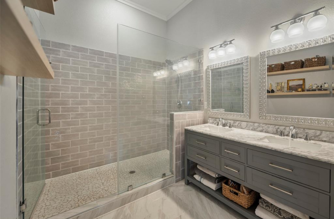 539 Elm Street New Ulm, TX 78950 - Photo 11 of 21 a bathroom with a double vanity sink mirror and shower