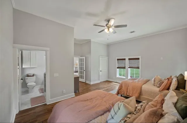 a bedroom with a large bed and a chandelier