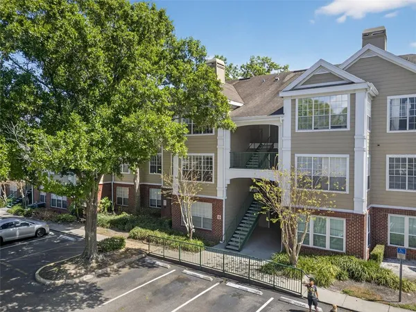 a front view of a residential apartment building with a yard