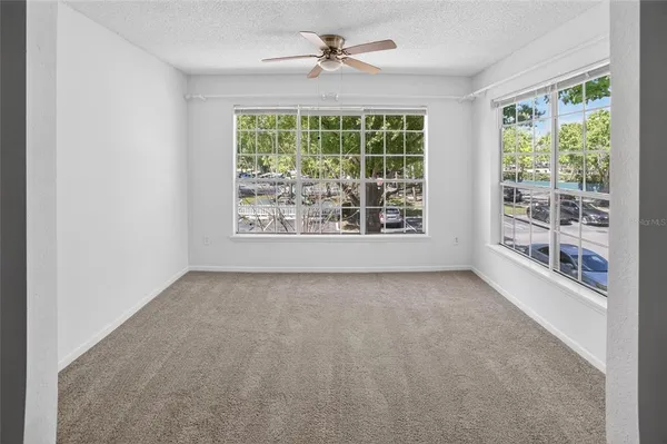 an empty room with windows and outdoor view