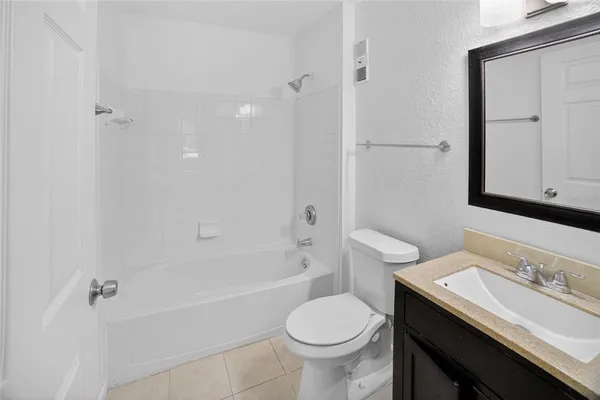 a bathroom with a sink toilet vanity and shower