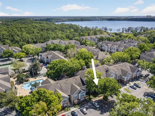 an aerial view of a house with garden space and street view