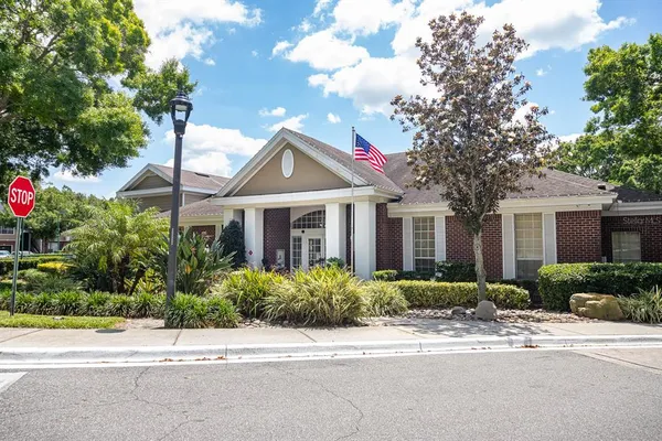 a front view of a house with a yard and outdoor seating