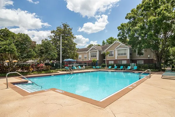 a view of a house with swimming pool and sitting area