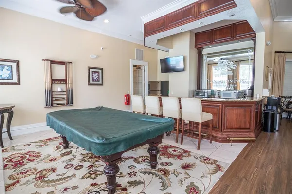 a room with furniture and view of kitchen