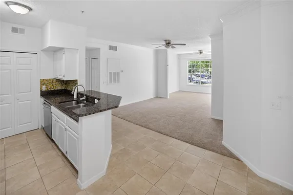 a kitchen with granite countertop a stove and a refrigerator
