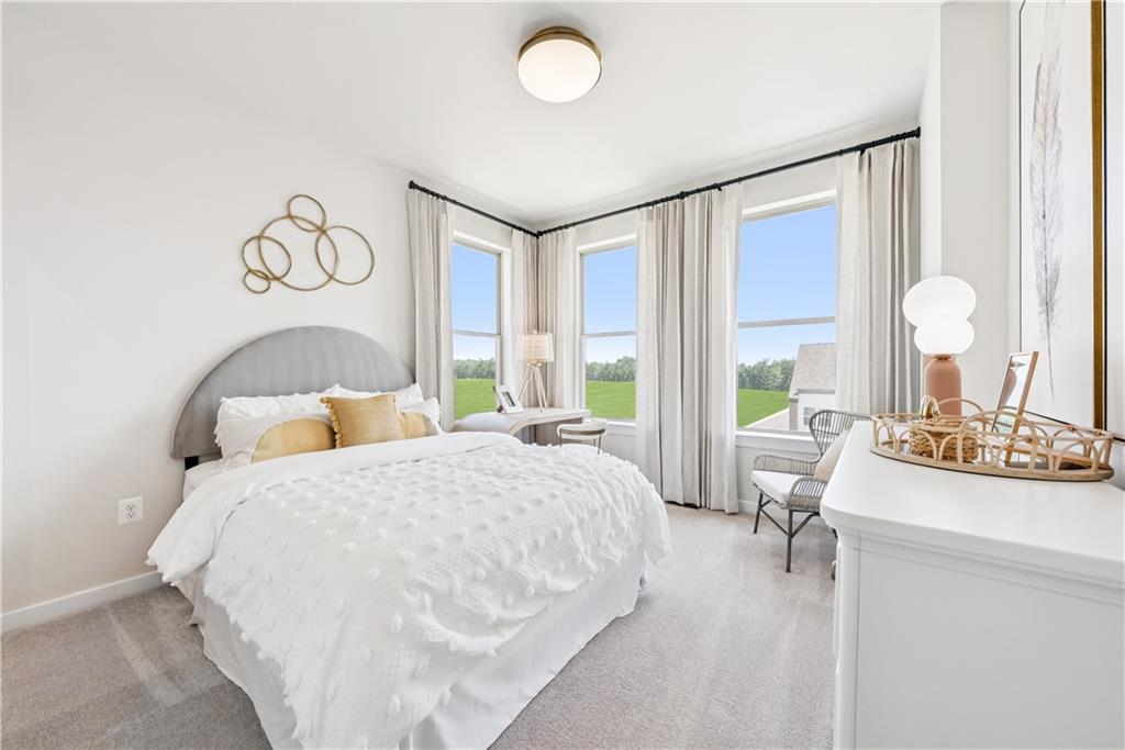 316 Skylar Court Southeast, Unit 94 Atlanta, GA 30312 - Photo 17 of 30 a bedroom with a bed and a table