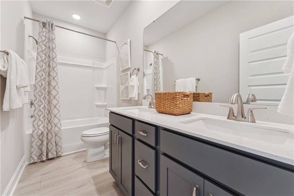 316 Skylar Court Southeast, Unit 94 Atlanta, GA 30312 - Photo 19 of 30 a bathroom with a granite countertop sink toilet and shower