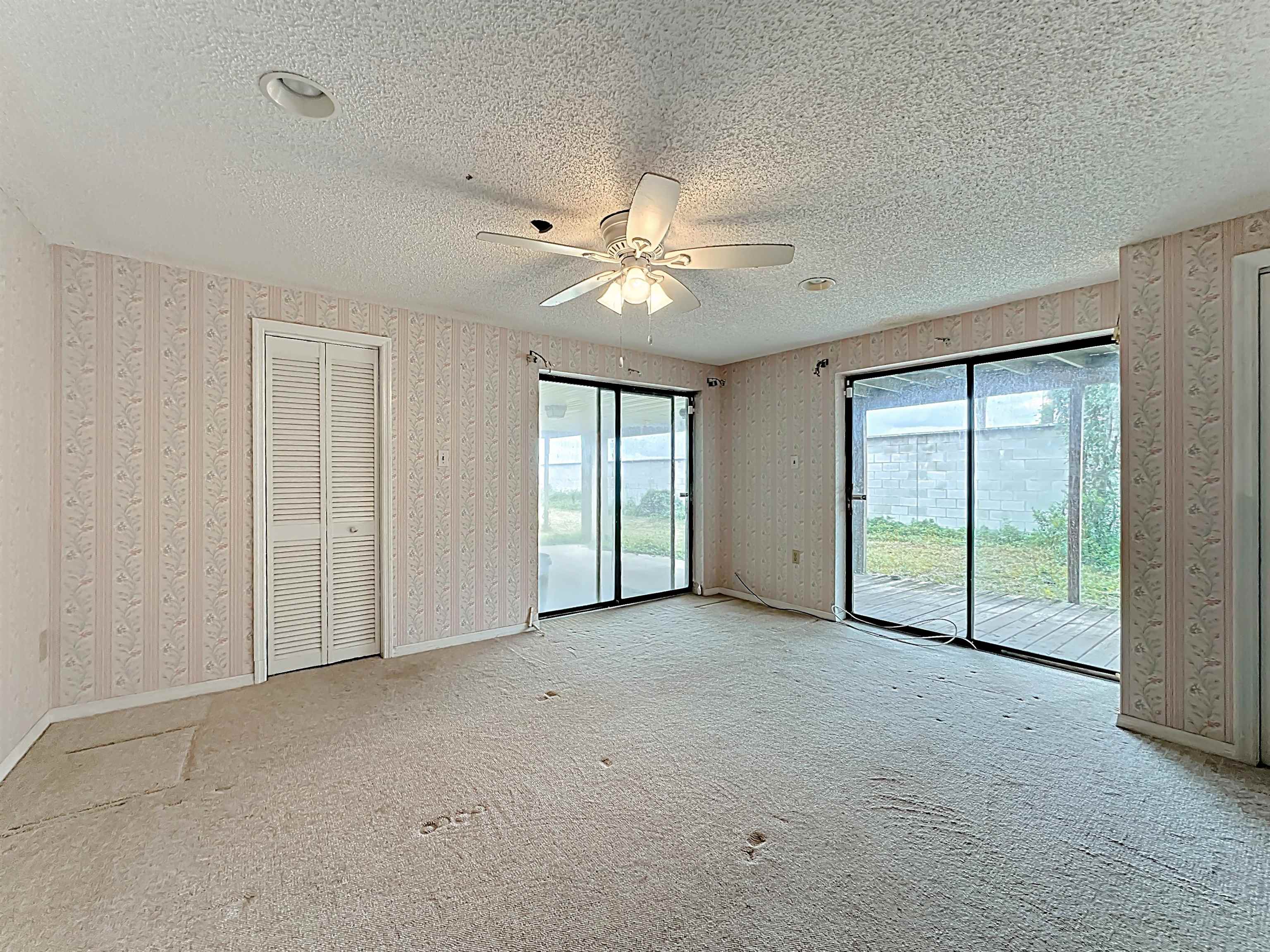 17 Salt Run Court St. Augustine, FL 32080 - Photo 14 of 33 an empty room with chandelier fan and windows
