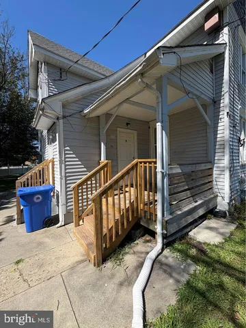 a view of backyard with tub and wooden fence