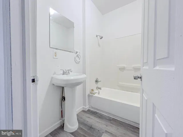 a bathroom with a sink a mirror and a bathtub