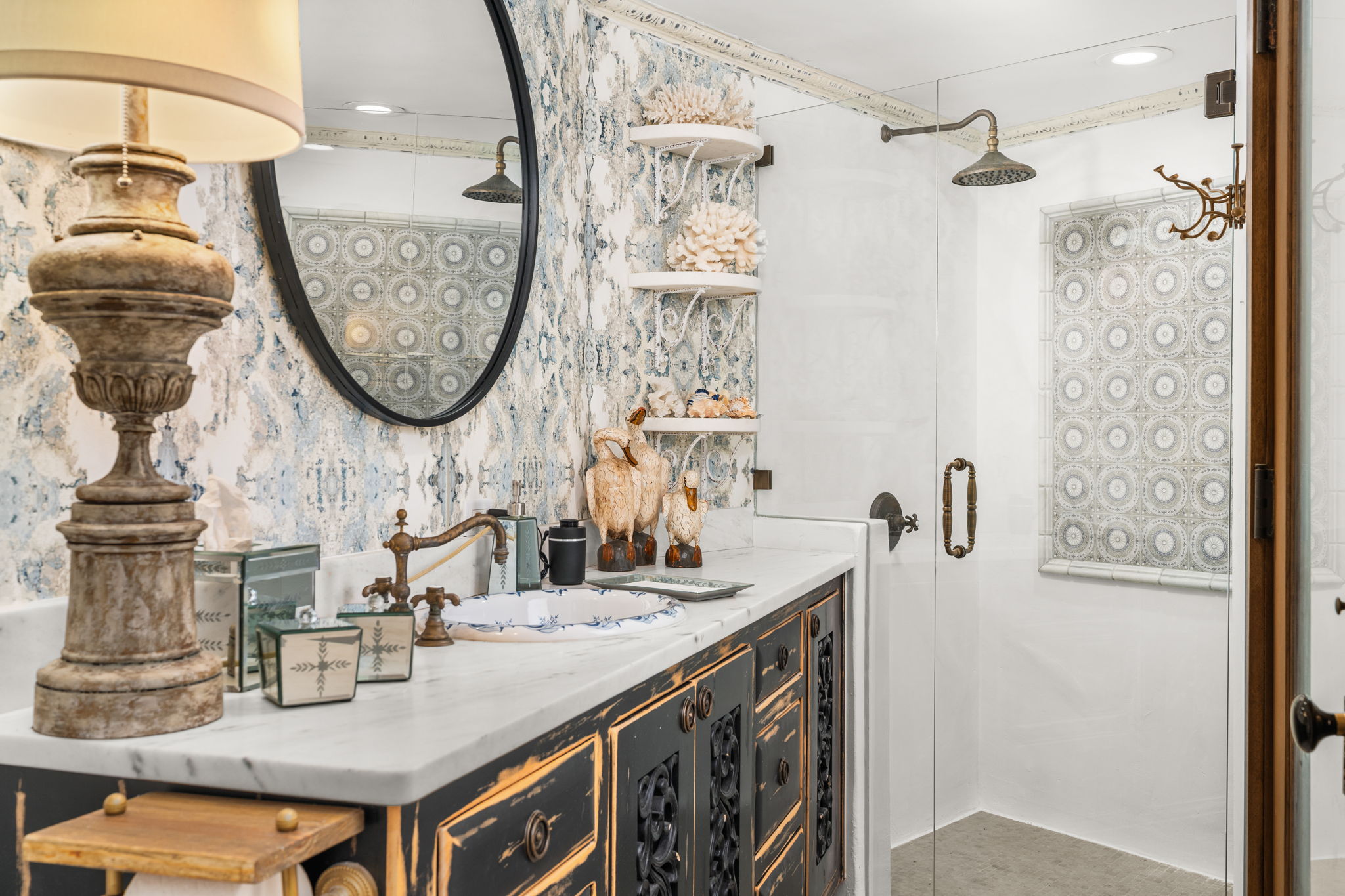 11941 Overlook Pass Austin, TX 78738 - Photo 30 of 40 Guest House Bathroom featuring a distressed black vanity with white countertop, an oval mirror, and a glass-enclosed shower with a patterned tile wall