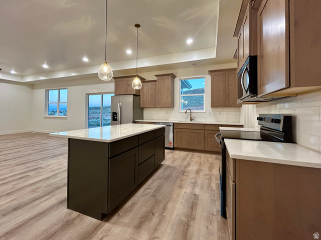 6 South 450th West Gunnison, UT 84634 - Photo 9 of 45 Open-concept kitchen with a central island featuring a white countertop, recessed lighting, and pendulum fixtures