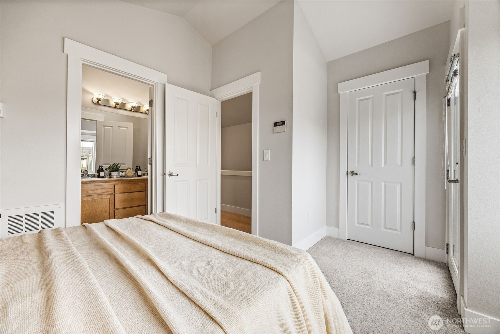 910 Northwest 85th Street, Unit B Seattle, WA 98117 - Photo 15 of 21 a bedroom with a bed and a view of bathroom