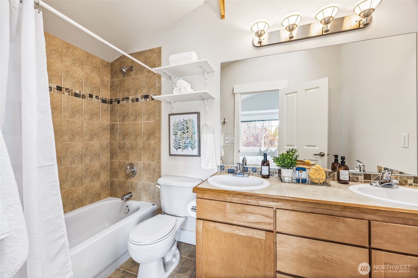 910 Northwest 85th Street, Unit B Seattle, WA 98117 - Photo 16 of 21 a bathroom with a sink mirror toilet and bathtub