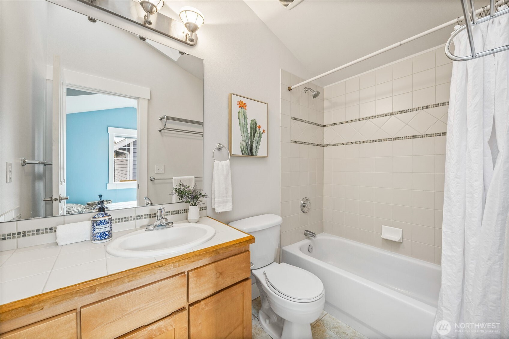 910 Northwest 85th Street, Unit B Seattle, WA 98117 - Photo 18 of 21 a bathroom with a sink mirror toilet and bathtub