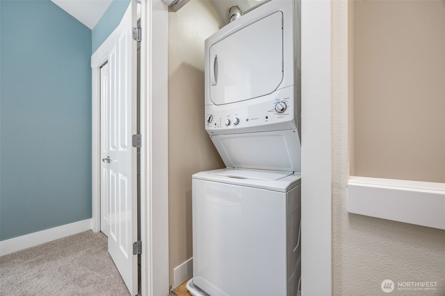 910 Northwest 85th Street, Unit B Seattle, WA 98117 - Photo 19 of 21 a view of washer and dryer with bathroom in the background