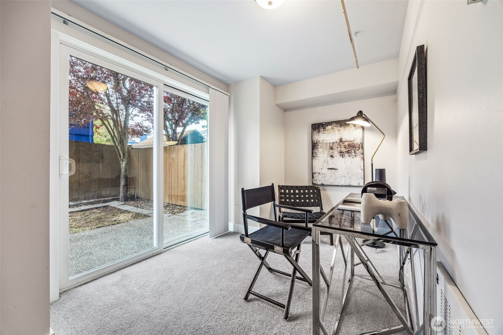 910 Northwest 85th Street, Unit B Seattle, WA 98117 - Photo 6 of 21 a work room with furniture and a floor to ceiling window