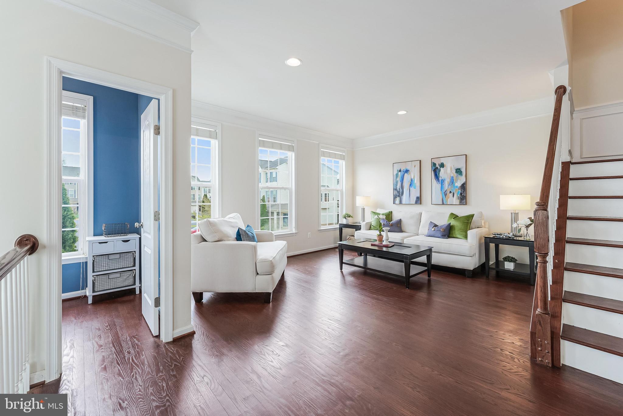 42467 Patrick Wayne Square Ashburn, VA 20148 - Photo 15 of 60 a living room with furniture and a wooden floor