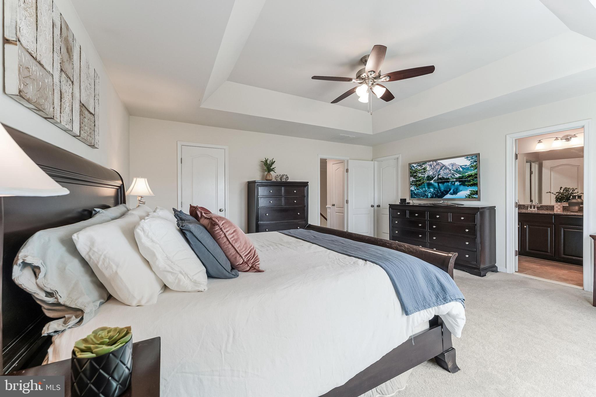 42467 Patrick Wayne Square Ashburn, VA 20148 - Photo 19 of 60 a bedroom with a bed and ceiling fan