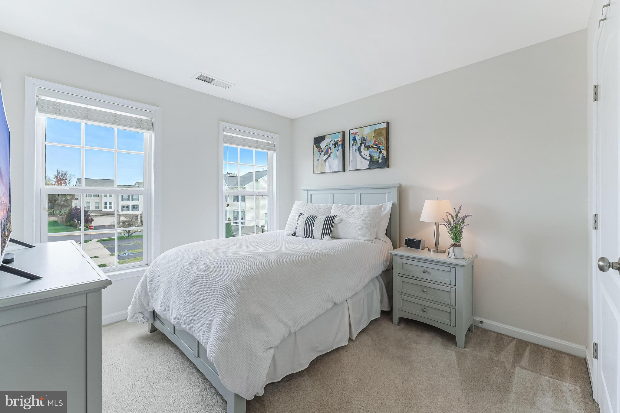 42467 Patrick Wayne Square Ashburn, VA 20148 - Photo 24 of 60 a bedroom with a bed next to a large window