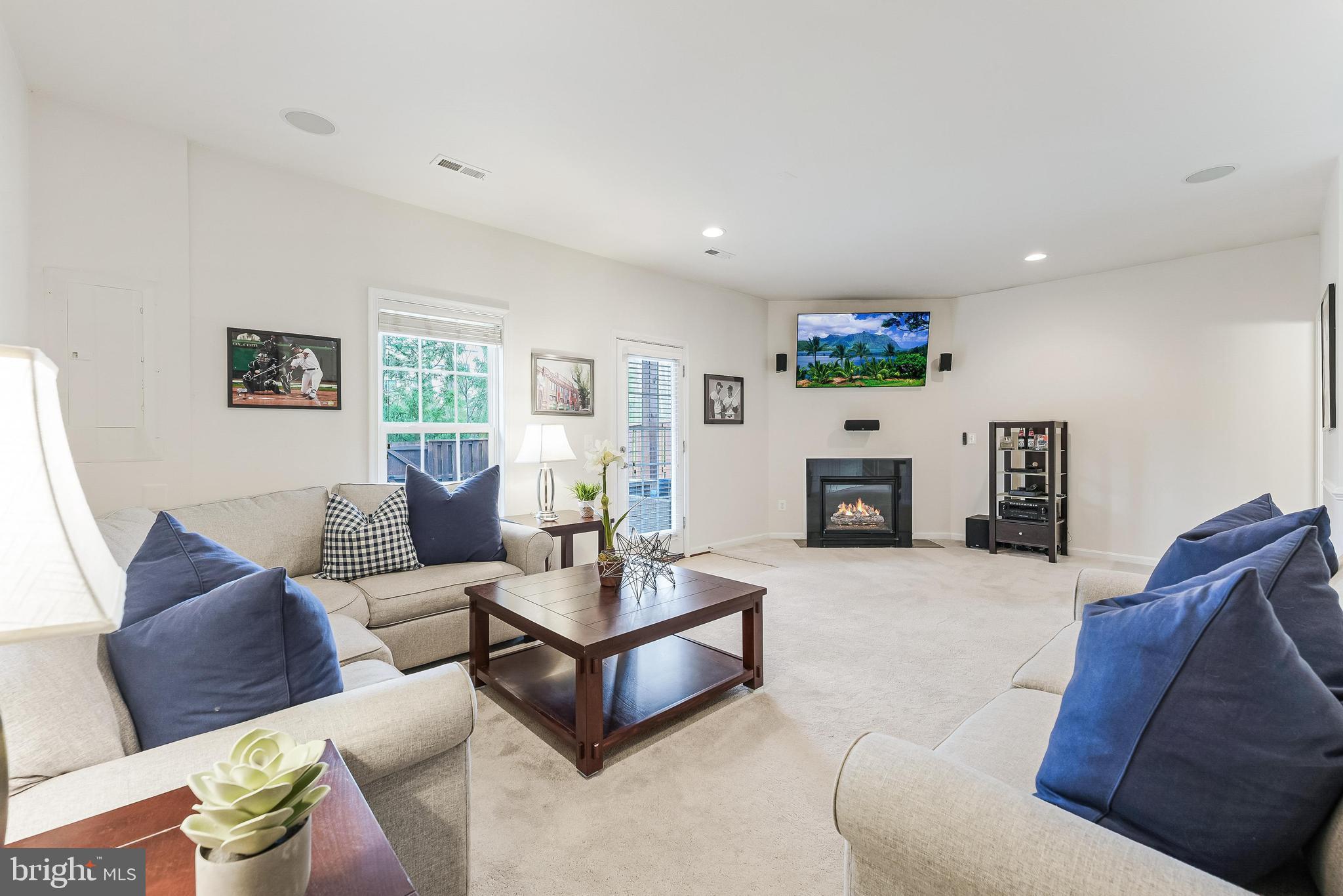 42467 Patrick Wayne Square Ashburn, VA 20148 - Photo 36 of 60 a living room with furniture and a fireplace