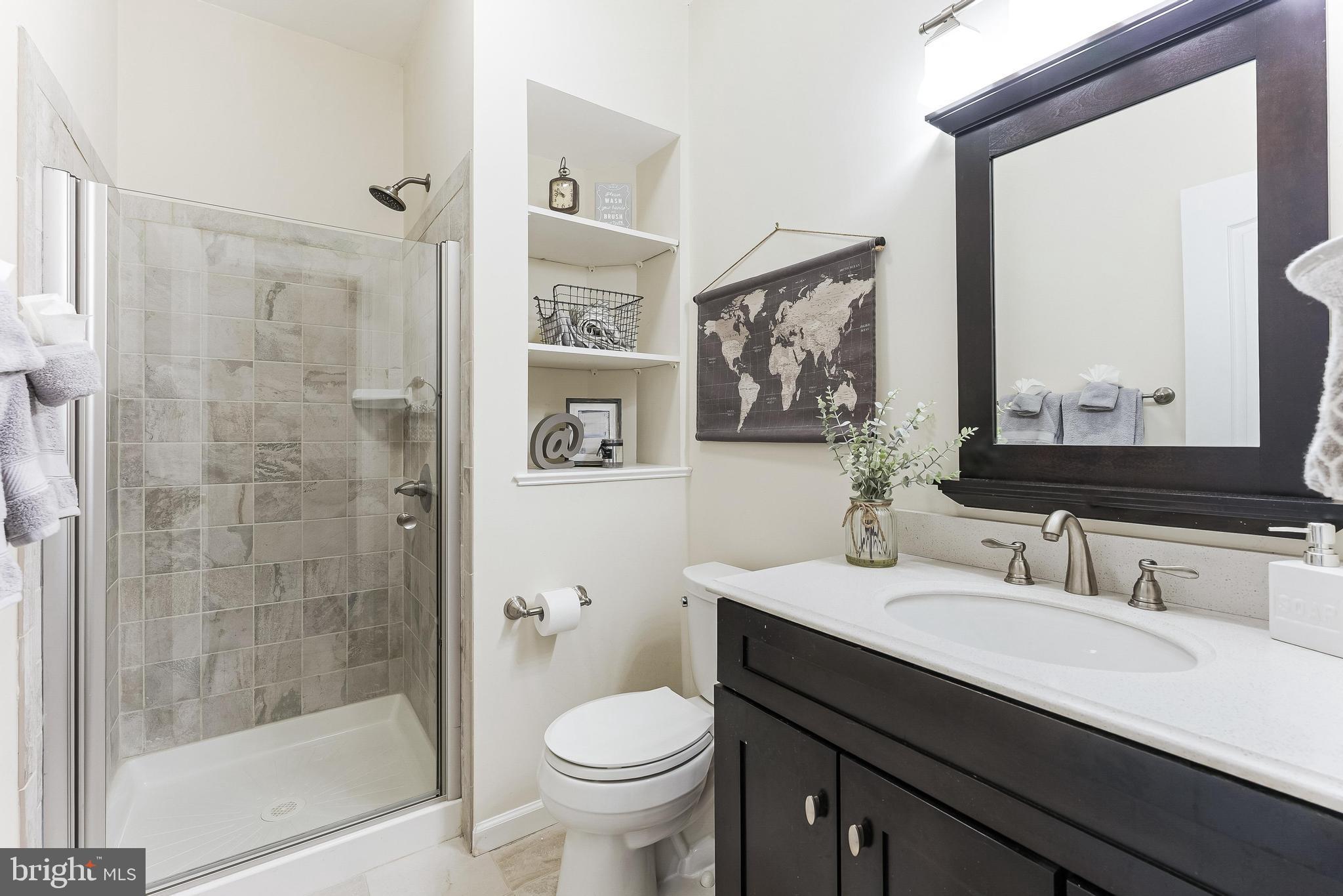 42467 Patrick Wayne Square Ashburn, VA 20148 - Photo 39 of 60 a bathroom with a sink a toilet and shower