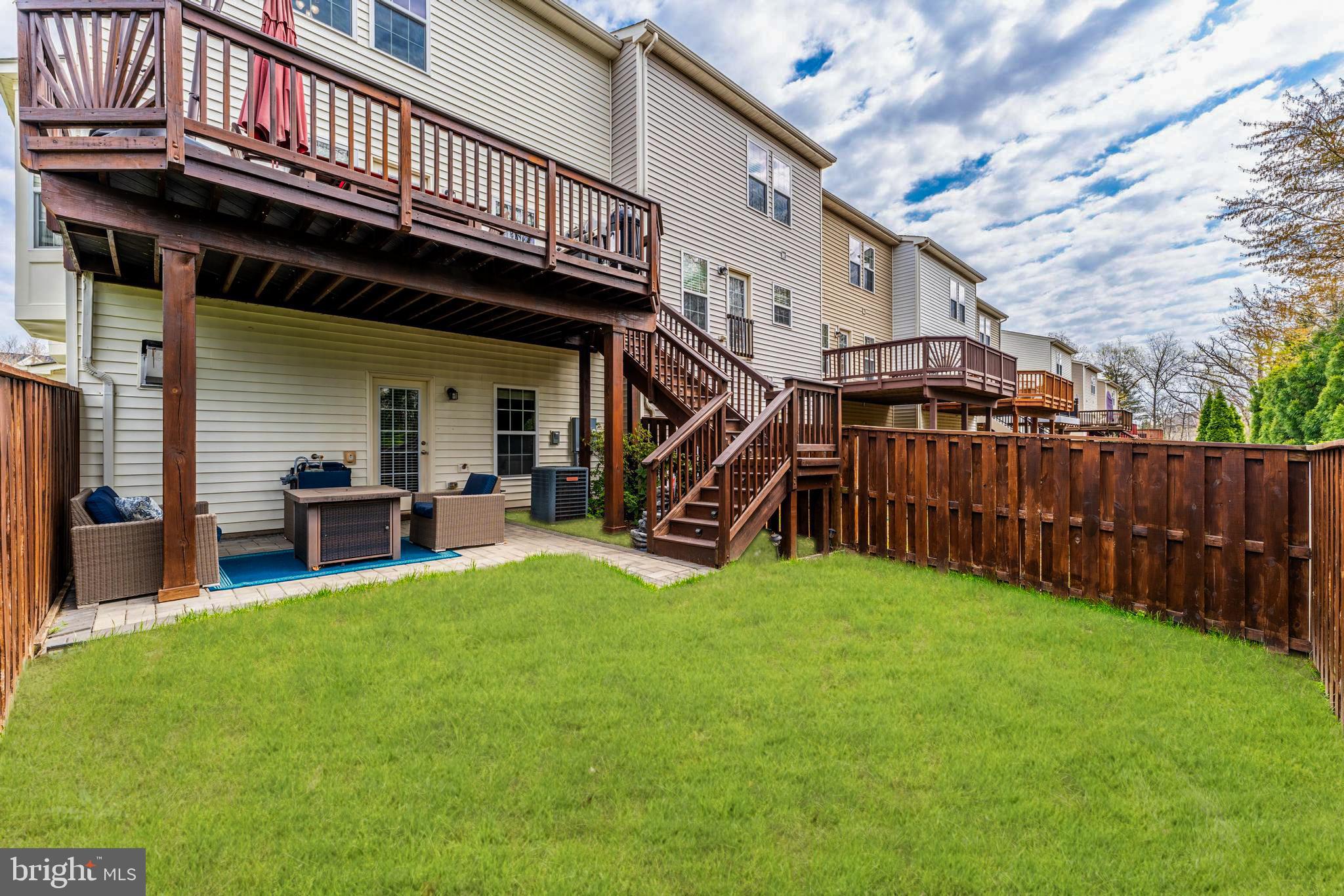 42467 Patrick Wayne Square Ashburn, VA 20148 - Photo 44 of 60 a view of a house with a yard deck and a large tree