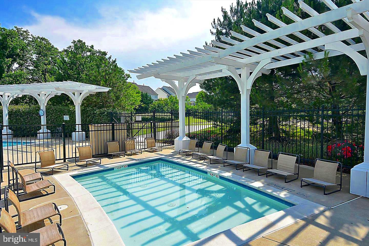 42467 Patrick Wayne Square Ashburn, VA 20148 - Photo 48 of 60 a view of a patio with a dining table and chairs with wooden floor and fence