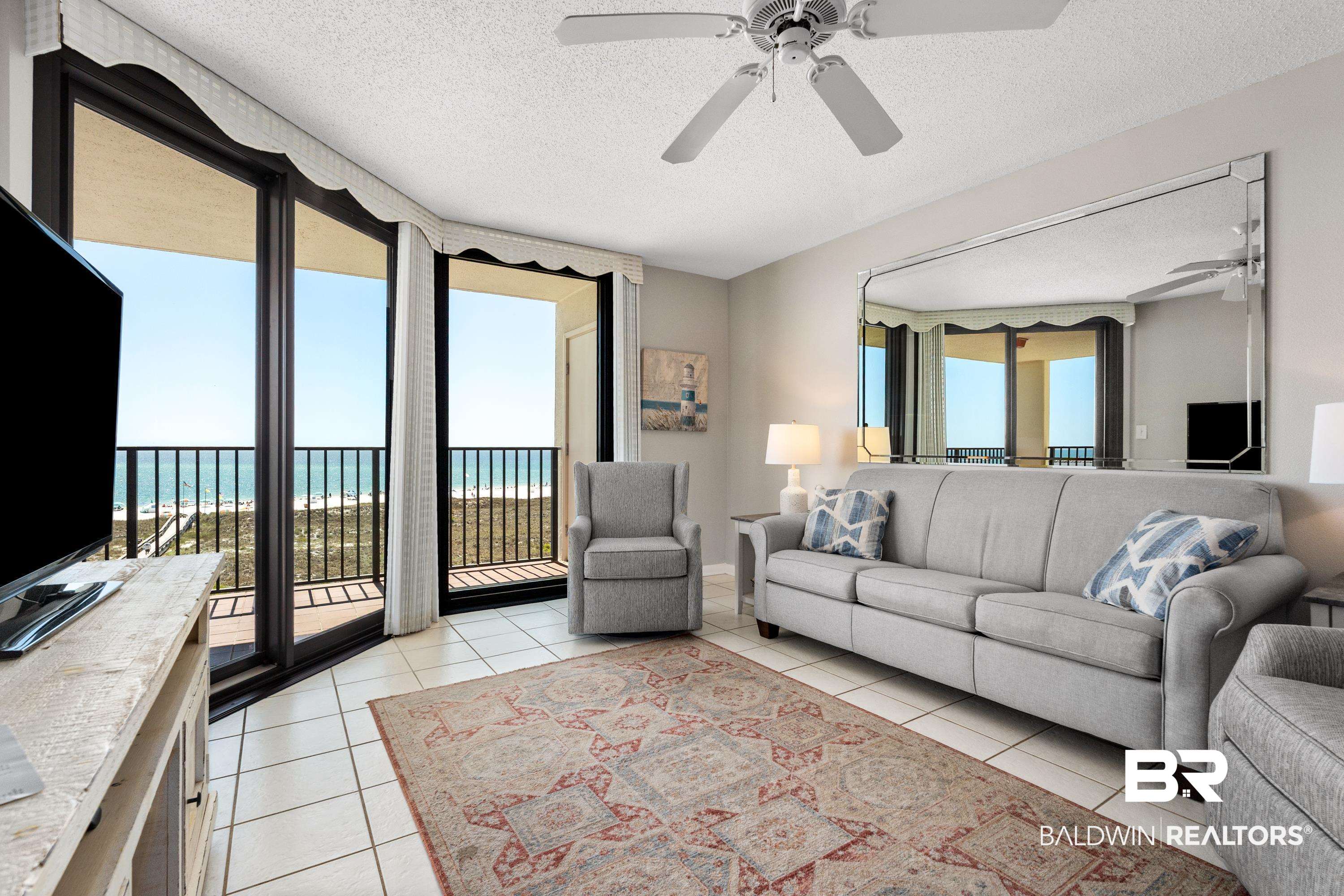 26802 Perdido Beach Boulevard, Unit 406 Orange Beach, AL 36561 - Photo 4 of 37 Living room featuring a textured ceiling and a ceiling fan