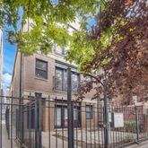 a front view of a house with a tree