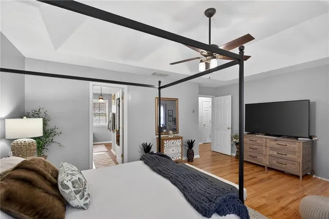 a bedroom with a bed window and television