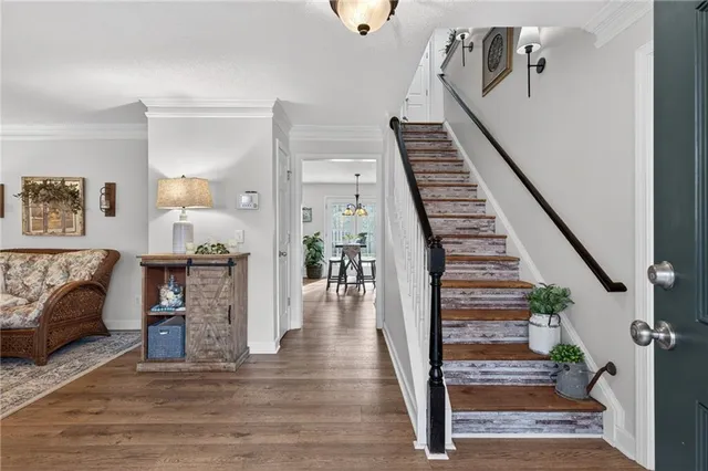 a view of entryway and hall with wooden floor