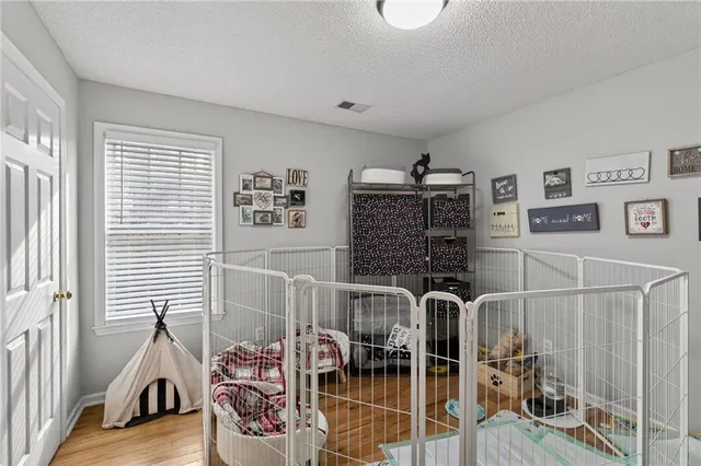 a front view of a house with yard and tree s