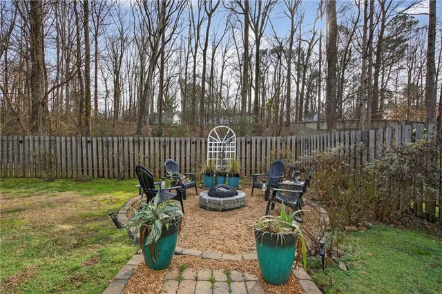 a view of a house with backyard and sitting area