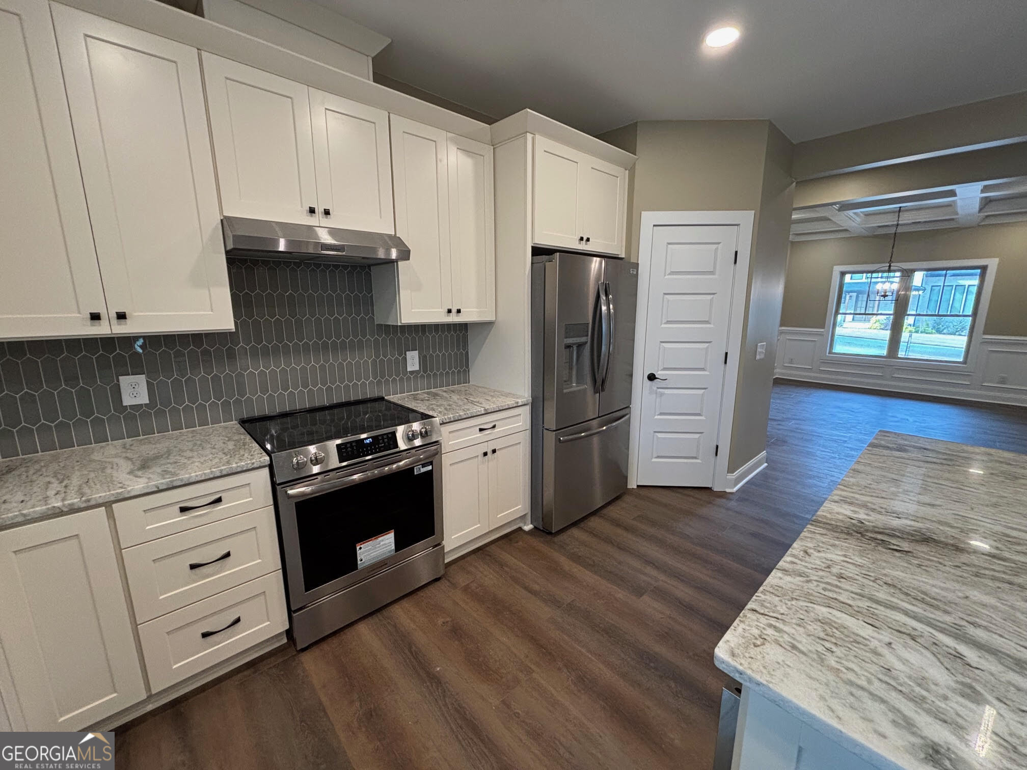 178 Samson Way Cleveland, GA 30528 - Photo 6 of 32 a kitchen with granite countertop a refrigerator stove and wooden cabinets