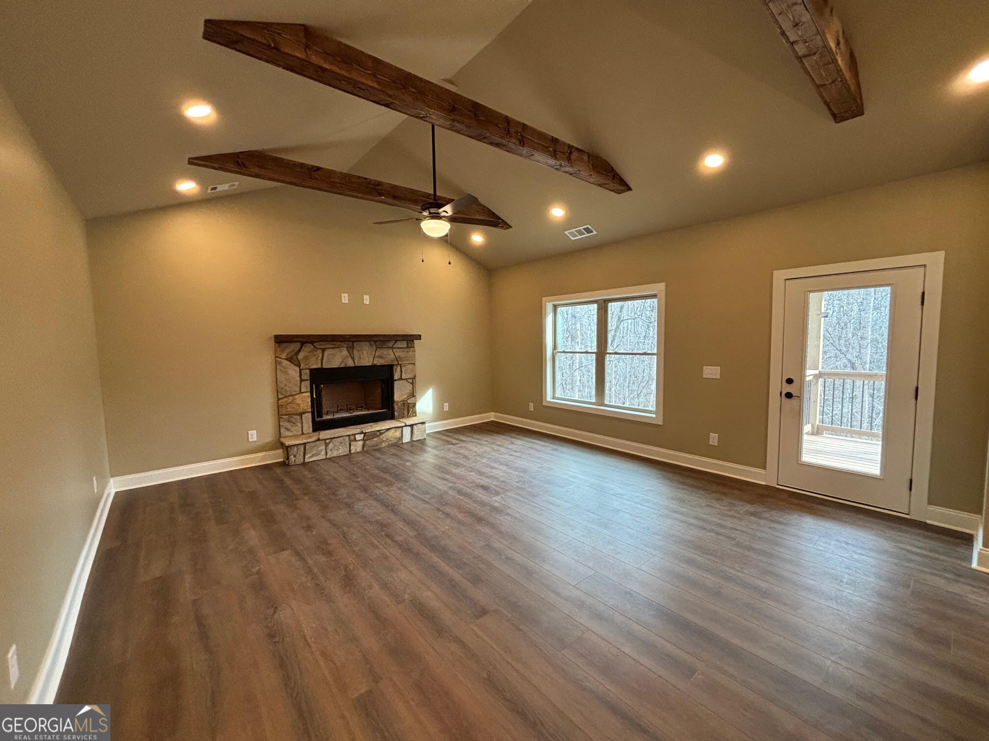 178 Samson Way Cleveland, GA 30528 - Photo 8 of 32 an empty room with wooden floor fireplace and windows