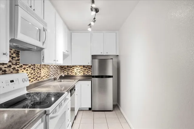 a view of a kitchen counter space and stove top oven