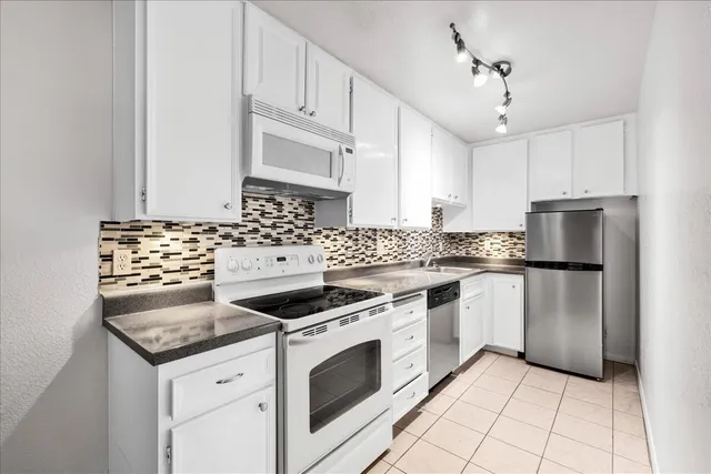 a close view of a sink a stove and cabinets