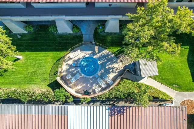 a view of a patio with table and chairs potted plants and large tree