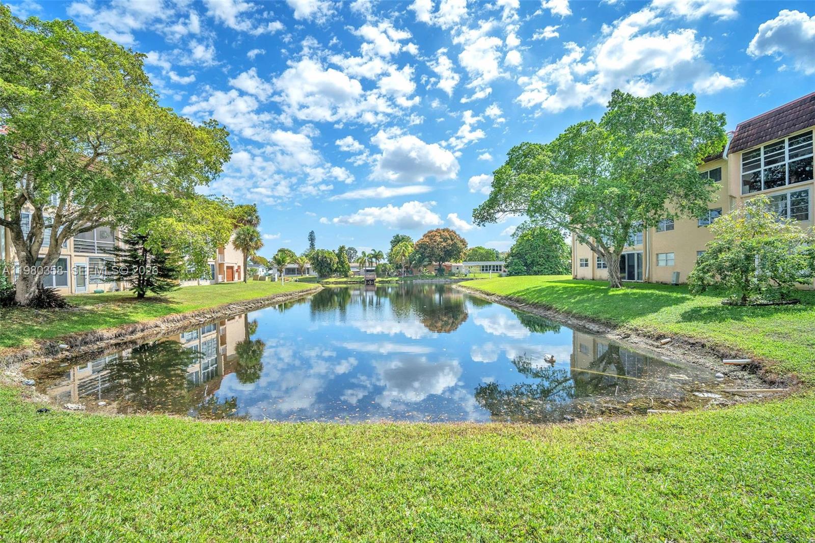 2720 North Pine Island Road, Unit 306 Sunrise, FL 33322 - Photo 11 of 23 a view of a lake with a yard