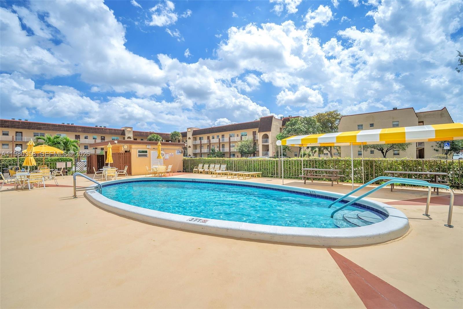 2720 North Pine Island Road, Unit 306 Sunrise, FL 33322 - Photo 16 of 23 a view of a swimming pool with a patio